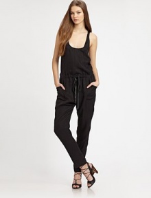 This statement-making one-piece is cinched at the waist by a rich leather drawstring and finished with a skin-baring crossover back.ScoopneckSleevelessBlouson bodiceDrawstring waistSlash pocketsCrossover backRise, about 10Inseam, about 2959% cupro/41% lyocellDry cleanImportedModel shown is 5'10 (177cm) wearing US size 4.