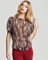 Lend a hint of the exotic to the ensemble with this GUESS snake-print top, fashioned in an elegant, billowy silhouette.