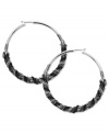 Twist the night away in these fun hoops from GUESS. The classic silhouette gets wrapped with jet and hematite tone chain detail. Crafted in silver tone mixed metal. Approximate diameter: 2 inches.