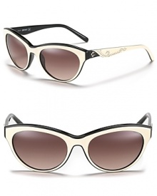 Western-inspired cat eye sunglasses with contrast interior and studded sides.