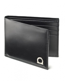 In fine Italian leather unsurpassed, Salvatore Ferragamo has created the Gancio billfold. A modern wallet with metal Gancini logo on front. Multiple card slots in the interior. In fine Italian leather unsurpassed, Salvatore Ferragamo has created the Gancio billfold. A modern wallet with metal Gancini logo on front. Multiple card slots in the interior.