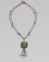 From the Trujillo Collection. Two delicate beaded strands hold a striking plaque of rainbow calsilica encased in rock crystal with a beaded tassel.Turquoise, jasper, rainbow calsilica and crystalBronzeLength, about 29Carved toggle claspMade in USA