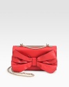 Sumptuous leather in a demure flap design topped with a pretty bow and a polished chain strap.Detachable adjustable shoulder strap, 12-22½ dropFlap snap closureProtective metal feetTwo inner compartmentsOne inside open pocketCotton lining9¾W X 5¾H X 2DMade in Italy