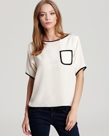 This silk Tucker top features smart black piping and at the neckline, sleeves and chest patch pocket--a sophisticated way to work the color-blocking trend at the office.