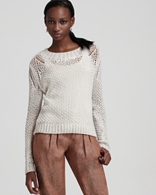 The hand-knit Theory sweater exudes weekend chic, touting a breezy open weave in rich ivory wool.