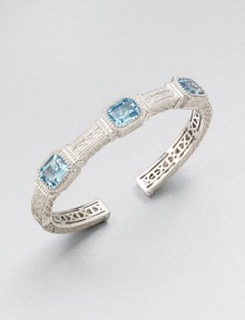 A highly intricate design with three emerald-cut blue topaz stones. Blue topazRhodium-plated sterling silverDiameter, about 2.25Slip-on styleImported 