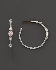 Faceted, oval-shaped pink crystals, flanked by hearts, bring romantic glamour to classic sterling silver hoop earrings.