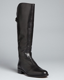 These Bettye Muller riding boots are flat-out perfect with high-gloss leather finished with criss-cross buckles at the back. These Bettye Muller riding boots are flat-out perfect with high-gloss leather finished with criss-cross buckles at the back.
