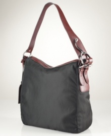 A laid-back silhouette gets an elegant upgrade with this haute hobo from Lauren Ralph Lauren. Sleek, durable nylon with equestrian-inspired stirrup hardware exudes functional style, while the rich leather accents add instant polish and sophistication. A laid-back silhouette gets an elegant upgrade with this haute hobo from Lauren Ralph Lauren. Sleek, durable nylon with equestrian-inspired stirrup hardware exudes functional style, while the rich leather accents add instant polish and sophistication.