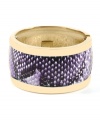 Slither into a little something stylish. Haskell's chic cuff bracelet features a gold tone mixed metal setting with a strip of purple snake print. Hinged design slips easily over the wrist. Approximate length: 8 inches.