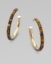 Beautifully textured tiger's eye-inspired beads set into a goldtone hoop for a unique look. Epoxy beadsGoldtone brassLength, about 1¾Post backImported 