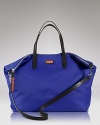 Indulge in a bag that can keep up with your plans. This durable nylon style from Cole Haan features a generous design and an optional long shoulder strap for added ease.