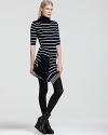 A fresh new-season find: this Cut25 dress touts variegated stripes and an unexpected ruffle at the asymmetric hem. Punctuate the downtown look with wedge booties for directional cool.