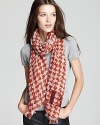 Burnt red and beige houndstooth and a BRIT logo decorate this sheer, wool scarf from Burberry.