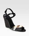 Traditional espadrille wedge topped with a patent leather slingback and signature check-print leather front. Hemp wedge, 4 (100mm)Patent leather and printed leather upperLeather liningRubber solePadded insoleMade in ItalyOUR FIT MODEL RECOMMENDS ordering one size up as this style runs small. 