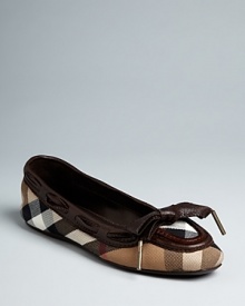 Burberry takes the prep-school good looks of a loafer into these streamlined ballet flats, tied up with a leather bow at the toe. Housecheck plaid defines this signature style.