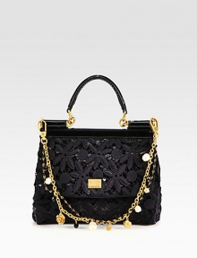 A truly feminine style that features pretty, cotton floral lace over shimmery sequins with patent leather trim and a detachable, embellished dual chain strap.Patent leather top handle, 3 dropDetachable embellished, dual chain shoulder strap, 8½ dropMagnetic snap flap closureOne inside open pocketSatin lining8W X 6¾H X 3½DMade in Italy A truly feminine style that features pretty, cotton floral lace over shimmery sequins with patent leather trim and a detachable, embellished dual chain strap.Patent leather top handle, 3 dropDetachable embellished, dual chain shoulder strap, 8½ dropMagnetic snap flap closureOne inside open pocketSatin lining8W X 6¾H X 3½DMade in Italy