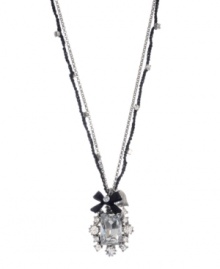 Elegance and flirtation combine. Betsey Johnson pendant highlights a Czech crystal surrounded by glass stones and accented by a ribbon charm. Crafted in silver tone mixed metal. Approximate length: 16 inches + 3-inch extender. Approximate drop: 1-1/2 inches.