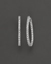 Prong set, inside out oval diamond hoop earrings set in white 14 Kt. gold. With hinged post.