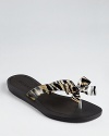 A bold leopard bow and glittering rhinestones add signature GUESS flair to the classic flip flop.