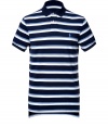 Detailed in ultra soft cotton pique, this striped polo is the epitome of the timeless classic Ralph Lauren look - Small navy collar, button placket, short sleeves, navy trim, embroidered polo player at chest, slit sides, high-low hemline - Classic cut - Wear with everything from jeans and sneakers to colored cords and loafers