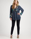 Colorful embroidery creates a lively effect for this peasant blouse with an elongating silhouette. Self-tie necklineLong sleevesEmbroidered detailsPull-on styleAbout 32 from shoulder to hemRayonMachine washImported