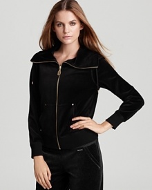 Laid-back luxury is embodied in this MICHAEL Michael Kors velour jacket, designed with a chic funnel neck and gleaming golden hardware. Laid-back luxury is embodied in this MICHAEL Michael Kors velour jacket, designed with a chic funnel neck and gleaming golden hardware.