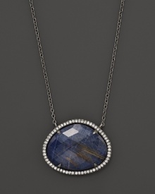 Diamonds circle a faceted rutilated quartz and blue sodalite doublet set in blackened sterling silver. By Di Massima. Diamonds circle a faceted rutilated quartz and blue sodalite doublet set in blackened sterling silver. By Di Massima.