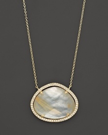 Diamonds circle a faceted rutilated quartz and mother-of-pearl doublet set in 18K yellow gold. By Di Massima.