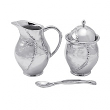 Shaped by hand of durable recycled aluminum, this striking creamer and sugar bowl from Mariposa are each detailed with a softly textured finish and beaded edges for a look that's at once organic and refined. Shaped by hand of durable recycled aluminum, this striking creamer and sugar bowl from Mariposa are each detailed with a softly textured finish and beaded edges for a look that's at once organic and refined.