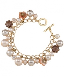 Pink perfection. Carolee's pretty glass pearl charm bracelet features ivory and peach hues, along with petite flower charms. Chain and toggle clasp crafted in 12k gold-plated mixed metal. Approximate length: 8 inches.