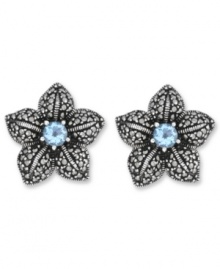 Springtime sparkle. Genevieve & Grace's delicate flower stud earrings feature a round-cut blue topaz center (1 ct. t.w.) with glittering marcasite petals. Crafted in sterling silver. Earrings feature an omega clip-on backing for non-pierced ears. Approximate diameter: 7/8 inch. Springtime sparkle. Genevieve & Grace's delicate flower stud earrings feature a round-cut blue topaz center (1 ct. t.w.) with glittering marcasite petals. Crafted in sterling silver. Earrings feature an omega clip-on backing for non-pierced ears. Approximate diameter: 7/8 inch.