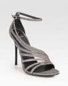 Glittery straps wrap around this chic after-hours pump, with a sexy heel and adjustable ankle strap. Metal heel, 5¼ (130mm)Glitter-coated fabric upperAdjustable ankle strapLeather lining and solePadded insoleImportedOUR FIT MODEL RECOMMENDS ordering true size. 