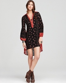 This Free People dress plays up the season's hippie mood, flaunting florals on a loose-fitting silhouette designed with bell sleeves and a of-the-moment high/low hem.