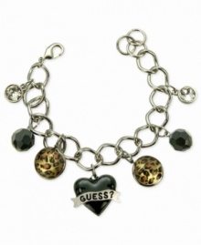 For the wild at heart, this charm bracelet from GUESS is crafted from silver-tone mixed metal with jet and glass crystal accents bringing a stylish edge. Leopard print enhances the animal attraction. Item comes packaged in a signature GUESS Gift Box. Approximate length: 7-1/2 inches. Approximate drop: 1 inch. Approximate diameter: 1-1/2 inches. For the wild at heart, this charm bracelet from GUESS is crafted from silver-tone mixed metal with jet and glass crystal accents bringing a stylish edge. Leopard print enhances the animal attraction. Item comes packaged in a signature GUESS Gift Box. Approximate length: 7-1/2 inches. Approximate drop: 1 inch. Approximate diameter: 1-1/2 inches.