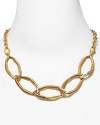 Make a molten statement with this gold-tone choker from T Tahari. With an abstract interlocking link design, it instantly defines every neckline.