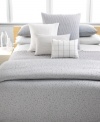 Inspired by the Greek island of Mykonos, Calvin Klein's Mykonos Pewter duvet cover features a textured circle pattern dispersed across a jacquard woven satin ground in muted tones of gray, white and blue. Hidden button closure.