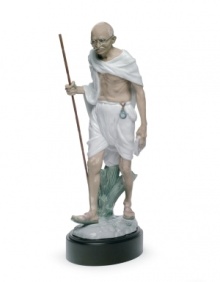 An homage to political activist and revered philosopher Mahatma Gandhi, this elaborate Lladro collectible depicts the historic figure in artfully glazed porcelain. An homage to political activist and revered philosopher Mahatma Gandhi, this elaborate Lladro collectible depicts the historic figure in artfully glazed porcelain.