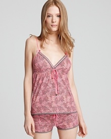 Treat yourself with this pretty pink printed camisole trimmed with lace.