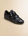 Racy patent leather, trimmed in mesh, with dual grip-tape straps for easy on/off.Patent leather and mesh upper Adjustable grip-tape straps Rubber sole Imported