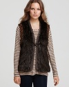 This plush GUESS faux fur vest flaunts ornately beaded armholes for a glamorous finish.