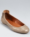 Dramatic detailing and a metallic finish elevate the classic ballet flat to stylish new heights. By Calvin Klein.