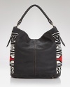 A boho's it-bag for the season: this hobo from Isabella Fiore brings a free spirited vibe to your wardrobe essentials with a mix of buttery leather and tassel detailing.