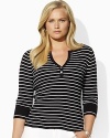 A deep split neckline finished with silver-toned buttons lends modern allure to a classic striped Henley in soft ribbed cotton.