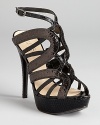 Snakeskin embossed leather mingles with glamorous black glitter on GUESS's Korina sandals, a sparkling style for evening.