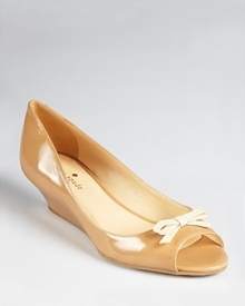 kate spade new york's Tracey wedges give a little lift with a lot of chic. In glossy patent and a ladylike bow, these classic peep toes are going places. kate spade new york's Tracey wedges give a little lift with a lot of chic. In glossy patent and a ladylike bow, these classic peep toes are going places.