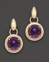 Centered on a brilliant, faceted amethyst gem, this elegant drop earring features a polished 14 Kt. setting with twist gold accents.