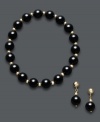 A bold, new look. Black onyx beads (8 mm) and 14k gold beaded accents adorn this matching jewelry set. Wear the stretch bracelet and drop earrings separate or together for a dramatically-stylish look. Approximate bracelet diameter: 3-1/2 inches. Approximate earring drop: 3/4 inch.