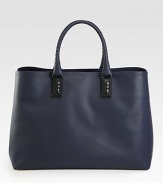 Charming coated canvas tote finished with signature woven handles and a spacious interior.Top handlesInterior zip pocketCotton liningCoated canvas19W x 13H x 8DMade in Italy