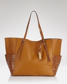 Add sleek chic to your daily routine with Michael Kors' crocodile-embossed tote. Carry the classy bag to lend exotic appeal to daily jaunts and tropical retreats--it likes to travel in style. Add sleek chic to your daily routine with Michael Kors' crocodile-embossed tote. Carry the classy bag to lend exotic appeal to daily jaunts and tropical retreats--it likes to travel in style.